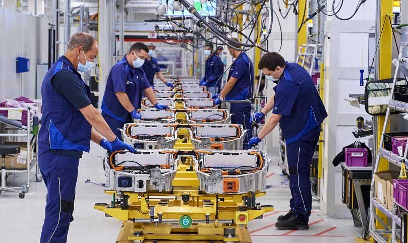 Männer arbeiten am Fließband eines Auto Herstellers